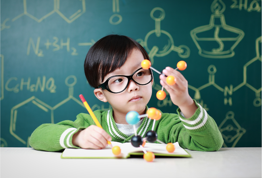 Boy studying molecule building block tools