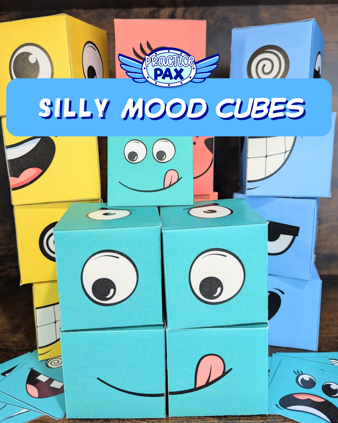 Silly mood cubes with cartoon faces and 'Practice Pax' branding on a wooden background