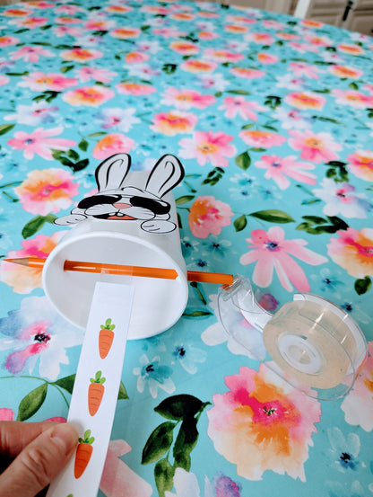 carrots on paper coming out of a cup with a bunny